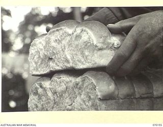 DUMPU, NEW GUINEA. 1944-02-05. THIS PICTURE INDICATES THE FINE TEXTURE OF ROLLS PRODUCED BY MEN OF THE 24TH INFANTRY BATTALION, AT THE 15TH INFANTRY BRIGADE BAKERY. THE RECIPE CONTAINS 6% WHEAT ..