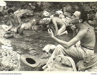 KILIGIA, PAPUA, NEW GUINEA. 1944-04-03. ALLIED SERVICEMEN FROM UNITS IN THE VICINITY AT HEADQUARTERS 5TH DIVISION BATHING, WASHING, AND SHAVING IN THE SWALLOW WATER NEAR THE MOUTH OF THE TUNOM ..