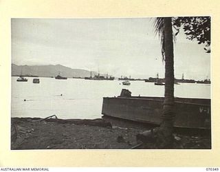 MILNE BAY, NEW GUINEA. 1944-02-09. A SECTION OF THE WATERFRONT AT MILNE BAY VIEWED FROM THE HEAD OF THE BAY TOWARDS THE NORTHERN SHORE. THE SITE OF NO. 3 AIRSTRIP (TURNBULL) LIES JUST BELOW THE ..