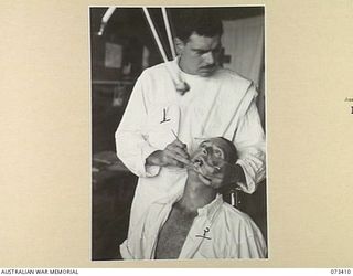 LAE, NEW GUINEA. 1944-05-24. QX50605 CAPTAIN L.R. BOYS (1), A DENTAL OFFICER AT THE 2.7TH GENERAL HOSPITAL GIVES DENTAL TREATMENT TO NX124335 PRIVATE EDWARDS (2), A MEMBER OF THE 2.162ND SUPPLY ..