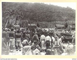 FAURO ISLAND, BOUGAINVILLE AREA. 1945-10-01. UNLOADING AND SEARCHING OPERATIONS IN PROGRESS AS JAPANESE MEDICAL PATIENTS FROM THE BUIN AREA ARRIVE BY LANDING BARGE AT THE NEWLY CONSTRUCTED HOSPITAL ..