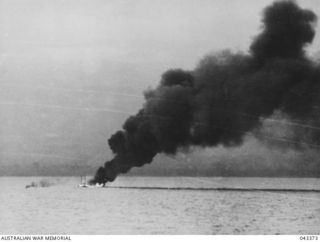 GUADALCANAL AREA, 1942. UNITED STATES DESTROYER, USS ELLET ON FIRE. THE NEARBY TRANSPORT HAS ALSO BEEN HIT