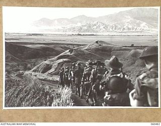 RAMU VALLEY AREA, NEW GUINEA. 1943-11-09. UNITS OF THE 21ST AUSTRALIAN INFANTRY BRIGADE MARCHING ALONG A WINNIND TRACK IN THE FOOTHILLS OF THE FINISTERRE RANGES ON THEIR WAY TO THE RAMU VALLEY ..