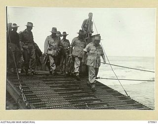 TOKO, SOUTH BOUGAINVILLE. 1945-03-26. VX1 GENERAL SIR THOMAS BLAMEY, GBE, KCB, CMG, DSO, ED, COMMANDER- IN- CHIEF, ALLIED LAND FORCES, SOUTH WEST PACIFIC AREA (1), COMING ASHORE FROM A LANDING ..