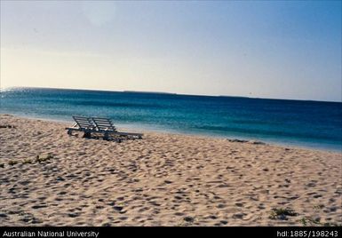 New Caledonia - white beach with lounge chairs