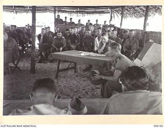 CAPE WOM, NEW GUINEA, 1945-12-01. PRIVATE G.C. PARSONS GIVING EVIDENCE AT THE TRIAL OF LIEUTENANT TAZAKI, WHO WAS CHARGED WITH AND LATER SENTENCED TO DEATH FOR CANNIBALISM, MUTILATING AND EATING ..