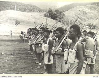 NADZAB, NEW GUINEA. 1944-09-26. B COMPANY, 1ST NEW GUINEA INFANTRY BATTALION AWAITING INSPECTION BY VX13 LIEUTENANT GENERAL S.G. SAVIGE, CB, CBE, DSO, MC, ED, GOC NEW GUINEA FORCE. NO. 6 PLATOON ..