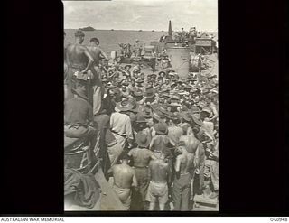 AT SEA NEAR AITAPE, NORTH EAST NEW GUINEA. 1944-04-21. PREPARED FOR ACTION, SUN-BROWNED PERSONNEL (SOME WEARING HATS) OF MOBILE WORKS UNITS, DESIGN AND SURVEY UNITS, AND SIGNALS UNITS, RAAF, GATHER ..