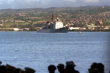 Sailors man the rails aboard the guided missile cruiser USS CHOSIN (CG-65) as the vessel approaches port during observance of the 50th anniversary of the Japanese attack on Pearl Harbor