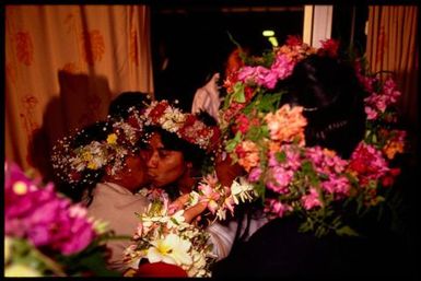 Women wearing 'ei upoko (head wreaths), Cook Islands