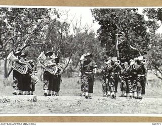 POM POM VALLEY, NEW GUINEA. 1943-11-27. BAND OF THE 18TH AUSTRALIAN INFANTRY BRIGADE MARCHING ON TO THE PARADE GROUND TO PLAY FOR THE CHAMPION GUARD OF THE UNIT DURING THE TAKING OF A TRAINING FILM ..