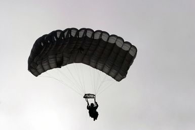 US Marine Corps (USMC) STAFF Sergeant (SSGT) David Hutton, 4th Force Reconnaissance Company (Force Recon Co), Kaneohe Bay, Hawaii (HI), Kaneohe Bay, Hawaii (HI), floats down during HALO (High Altitude Low Opening) military free fall training at Schofield Barracks in Oahu, HI