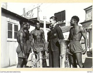 SYDNEY, NEW SOUTH WALES. 1945-03-28. RON SCHMIDT, (1), AMONG MEMBERS OF THE ROYAL PAPUAN CONSTABULARY BAND WHO ARE VISITING NEW SOUTH WALES TO ASSIST THE 3RD VICTORY LOAN. THE MEN PROVIDE FIRST ..