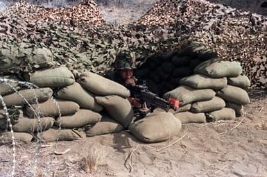 Private Norman Jack of the 25th Military Police Company uses an M60 machine gun to guard the entrance to the 25th MP Company's Tactical Operations Center during Exercise OPPORTUNE JOURNEY 4-84 at the Pohakuloa Training Area