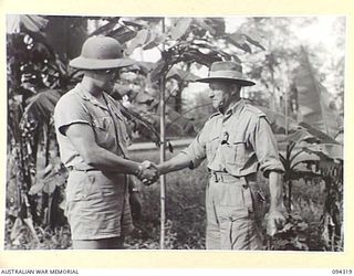 TOROKINA, BOUGAINVILLE. 1945-07-19. LIEUTENANT MILLER, AMENITIES OFFICER, 1 MARINE AIRCRAFT WING (US), WITH MAJOR W.A. OLDFIELD, AMENITIES OFFICER AT HEADQUARTERS 2 CORPS (2)