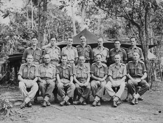 KILIGIA, NEW GUINEA, 1944-03-16. OFFICERS OF HEADQUARTERS, 5TH DIVISION SIGNALS SECTION. IDENTIFIED PERSONNEL ARE: QX39400 CAPTAIN A.J. HARLEN (1); VX47627 CAPTAIN G.P. HARPER (2); QX40794 MAJOR F. ..