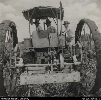 Field Officer and farmers on a tractor