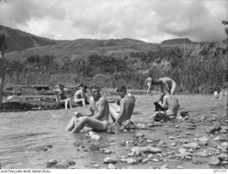 EVAPIA RIVER, NEW GUINEA, 1944-03-15. TROOPS OF THE 4TH FIELD REGIMENT WHO HAVE JUST COME DOWN FROM FORWARD POSITIONS IN THE HILLS BEYOND KESAWAI ARE PICTURED BUSILY WASHING THEMSELVES AND THEIR ..