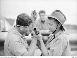 KIRIWINA, TROBRIAND ISLANDS, PAPUA. 1944-01-11. THE NASTY LOOKING CANNON OF A SPITFIRE AIRCRAFT ARE CONSTANTLY TESTED TO ENSURE THAT THEY FUNCTION PROPERLY IN ACTION. LEADING AIRCRAFTMAN D. G. ..