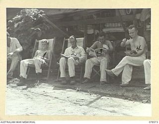 BOUGAINVILLE ISLAND. 1945-01-23. CONVALESCING PATIENTS RELAXING IN THE SUN OUTSIDE ONE OF THE WARDS OF THE 109TH CASUALTY CLEARING STATION
