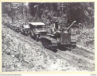 BOUGAINVILLE ISLAND. 1945-02-27. A JEEP TRAIN OF THE 7TH INFANTRY BRIGADE, LOADED WITH SUPPLIES FOR THE FORWARD TROOPS, MAKING ITS WAY THROUGH THE MUD AND SLUSH OF THE MOSIGETTA ROAD