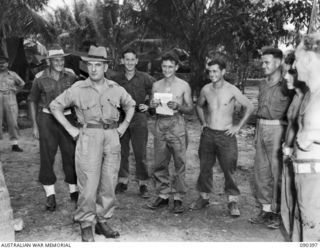 JACQUINOT BAY, NEW BRITAIN. 1945-04-08. SENATOR J.M. FRASER, ACTING MINISTER FOR THE ARMY (1), ACCOMPANIED BY LIEUTENANT COLONEL K.S. CUSWORTH, COMMANDING OFFICER (2), TALKING WITH MEN OF THE 29/46 ..