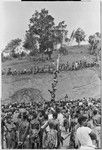 Government-sponsored festival in Tabibuga: men compete in greased pole-climb