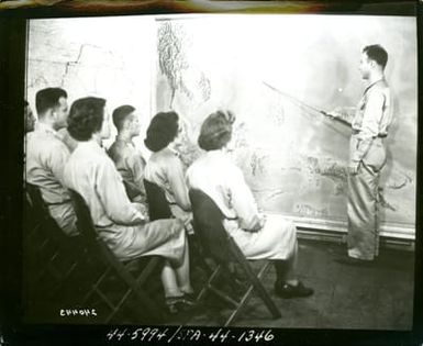 The Only Three WACs in the South Pacific Sit in the War Room Headquarters, South Pacific Base Command, New Caledonia, as Capt. Carlton Zucker, of Toledo, Ohio, Intelligence Officer, Explains One of the Headquarter's Daily Talks, Current Military Moves and Their Implication for the Future