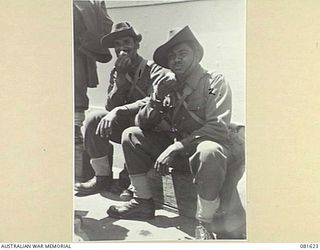SYDNEY, NEW SOUTH WALES. 1944-10-20. LANCE-NAIK MEHAR DIN (1), AND SEPOY NUR MOHD (2), MEMBERS OF THE 1ST BAHAWALPUR INFANTRY, (INDIAN ARMY), EATING BOILED EGGS BEFORE BOARDING THE BRITISH VESSEL ..