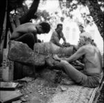 Lashing plank to hull of canoe