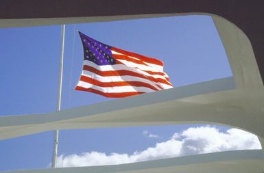 A flag flies at half-mast atop the USS ARIZONA (BB-39) Memorial to commemorate the 43rd anniversary of the Japanese attack