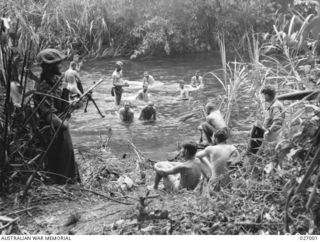 PAPUA, NEW GUINEA. 1942-09. MEN OF THE 2/31ST AUSTRALIAN INFANTRY BATTALION HAVING A BATHE IN THE BROWN RIVER, BETWEEN NAURO AND MENARI. IT WAS THEIR FIRST WASH FOR ABOUT 5 DAYS, DURING THE ADVANCE ..