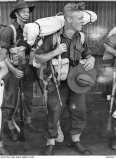 NX160250 (N185331) Private (Pte) Stanley Herbert Brown (foreground), and NX162028 Pte Thomas Oswald Watson, (behind), members of C Company, 2/4 Infantry Battalion, boarding the USS Mexico during ..