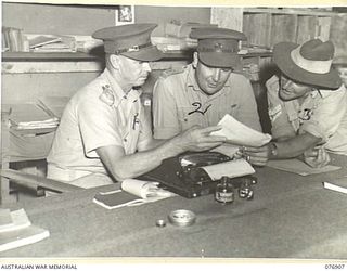 LAE, NEW GUINEA. 1944-11-15. NX18855 CAPTAIN A. MABBOTT, COMMANDING OFFICER (1) NX21768 LIEUTENANT L.J. CURRIE, ADJUTANT (2) AND QX51436 STAFF SERGEANT T.M. GREGG, COMPANY SERGEANT MAJOR (3) ..