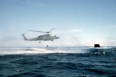 SEAL swimmers cast into the water from a HH-60H Seahawk helicopter during a SSN/Helo air/sea rendezvous with the nuclear-powered submarine USS KAMEHAMEHA (SSN-642) off the coast of Oahu, Hawaii. The KAMEHAMEHA is one of two former SSBN subs that have been converted to drydock shelter (DDS) capable platforms for special operations