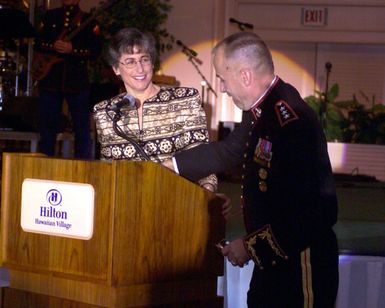 The Honorable Linda Lingle, Governor of Hawaii, is assisted with her note cards by US Marine Corps (USMC) Lieutenant General (LGEN) Wallace Gregson at the USMC Officer Ball, celebrating the 228th anniversary of the founding of the Marine Corps