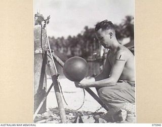 MILILAT, NEW GUINEA. 1944-09-14. 423607 SERGEANT F.W. BOYLE OF THE 5TH METROLOGICAL DETACHMENT, RAAF, ATTACHED TO THE 5TH DIVISION, FILLING A BALLOON WITH HYDROGEN TO OBTAIN THE EARLY MORNING WIND ..