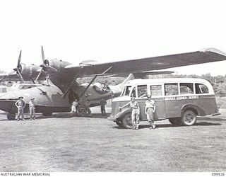 RABAUL, NEW BRITAIN, 1945-12-21. THE AIRCRAFT COURIER SERVICE BUS WHICH RUNS A SERVICE BETWEEN LAKUNAI AIRSTRIP AND THE VISITORS AND OBSERVERS SECTION. IT IS PARKED BESIDE THE RAAF CATALINA WHICH ..