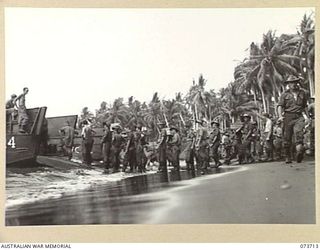 SARANG, NEW GUINEA. 1944-05-31. TROOPS OF THE 37/52ND INFANTRY BATTALION BEING LANDED AT THE BEACH. THE AREA IS IN USE AS A FORWARD BASE IN PREPARING FOR THE ATTACK AGAINST KARKAR ISLAND. ..