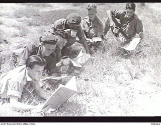 TOROKINA, BOUGAINVILLE, 1945-10-27. STUDENTS AT THE TOROKINA REHABILITATION TRAINING CENTRE HAVING THEIR TEA BREAK AT 10 O'CLOCK. IT IS PROVIDED BY THE AUSTRALIAN COMFORTS FUND DURING A 15 MINUTE ..