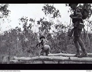 DONADABU, SOGERI VALLEY, NEW GUINEA. 1943-06-28. 25TH INFANTRY BATTALION ASSAULT COURSE. FIRST OBSTACLE - BALANCING ON NARROW PLANKS. LEFT TO RIGHT: Q103516 PRIVATE (PTE) C. W. CHURCH; N264816 PTE ..