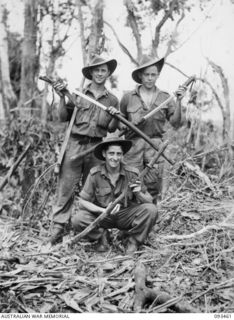 WEWAK AREA, NEW GUINEA. 1945-06-27. PRIVATE J.E. WHARTON (1); PRIVATE D.A. TAYLOR (2) AND PRIVATE L.E. CARMICHAEL (3), MEMBERS OF 2/8 INFANTRY BATTALION, DISPLAYING JAPANESE SWORDS PRIZED AS WAR ..