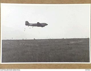 RAGITSUMA, NEW GUINEA, 1943-09-30. "BISCUIT BOMBERS". TRANSPORT AIRCRAFT DROPPING FOOD RATIONS TO FORWARD TROOPS OF THE 21ST AUSTRALIAN INFANTRY BRIGADE IN THE MARKHAM VALLEY