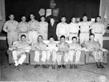 Indiana men met at a RED CROSS PARTY IN NEW CALEDONIA: (FRONT L-R) THEODORE ROGERS, BLOOMINGTON; MERIRLL GOBIN, GREENSBURG; CLARENCE MORRISON, GREENSBURG; CHARLES NICHEOLS, BRAZIL; WENDELL OWSLEY, PEKIN; GENE MCRAE, SELLERSBURG; (BACK L-R) NORMAN HOUSTON, INDIANAPOLIS; EARL MESSEMER, ST. ANTHONY; CHARLES SWEEZEY, GREENSBURG; PFC RALPH THOMAS, FORT WAYNE [UNIDENTIFIED WOMAN] LOUIS DEPPOTT, OTWELL; DALE BOGER, INDIANAPOLIS; DALE TRINKLE, PLYMOUTH; HARRY SELZER, BLOOMINGTON. HG-45-1857.