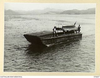 PORT MORESBY, PAPUA. 1944-10-21.ALC (AUSTRALIAN LANDING CRAFT) 5-AB 1004 OF THE 55TH PORT CRAFT COMPANY, SHOWING LOCAL MODIFICATIONS TO THE VESSEL, INCLUDING CANOPIES FORE AND AFT, NAVIGATION ..