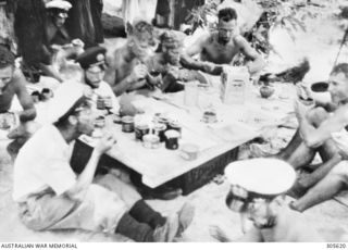 EMIRAU ISLAND. PASSENGERS AND CREW, AMONG THE 496 SURVIVORS WHO HAD BEEN CAST AWAY ON EMIRAU ISLAND IN THE BISMARCK ARCHIPELAGO AFTER THEIR MERCHANT SHIPS HAD BEEN SUNK BY GERMAN RAIDERS KOMET AND ..