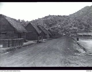 RABAUL, NEW BRITAIN, 1946-03-29. ONE OF THE MAIN STREETS IN THE NEW CHINATOWN SITUATED NEAR MATUPI CRATER. ALTHOUGH RAZED BY ALLIED BOMBING THE TOWN COMMENCED TO REAPPEAR SOON AFTER OCCUPATION BY ..