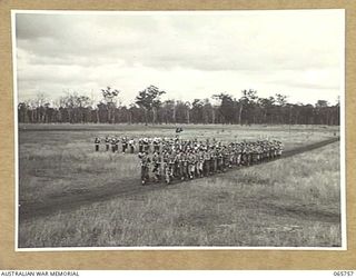 WONDECLA, QLD. 1944-04-15. A COMPANY OF THE 2/1ST INFANTRY BATTALION GIVE "EYES RIGHT" AS THEY MARCH PAST THEIR COMMANDING OFFICER, NX163 LIEUTENANT COLONEL P.A. CULLEN, DSO. (4), WITH THE ..