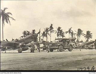 MOMOTE, LOS NEGROS ISLAND, ADMIRALTY ISLANDS. C. 1944-03. PILOTS OF NO. 76 (KITTYHAWK) SQUADRON RAAF BREAK FROM THEIR JEEP TRANSPORT WHILE IT IS STILL RUNNING AND MAKE FOR THEIR WAITING AIRCRAFT. ..