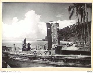 BUIN AREA, BOUGAINVILLE. 1945-09-28. JAPANESE BARGES LITTER THE BEACH NEAR KANGU HILL AS A RESULT OF ALLIED BOMBING